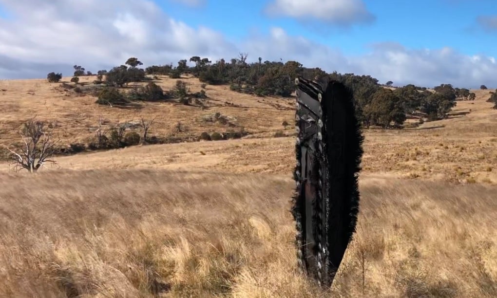 A black charred piece of metal stands in a field of yellow grassland. Brad Tucker, an astrophysicist at the Australian National University believes it is part of a SpaceX mission.