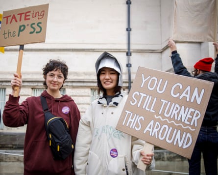 Two women holding placards.
