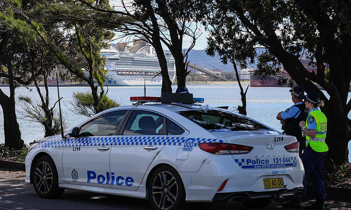 Police watch the Ruby Princess cruise ship docked at Port Kembla in Wollongong