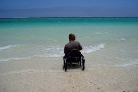 Kevin Hayley in a wheelchair facing the ocean