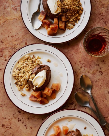 Dean Parker’s chocolate mousse with poached quince and brown butter milk crumb on plates on a table, with glasses and cutlery nearby