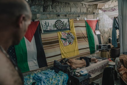 Group of people live in a makeshift tent inside the Nablus Municipal Stadium.