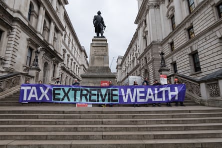A rally in support of taxing the super-rich outside the Treasury in London on 25 March 2025