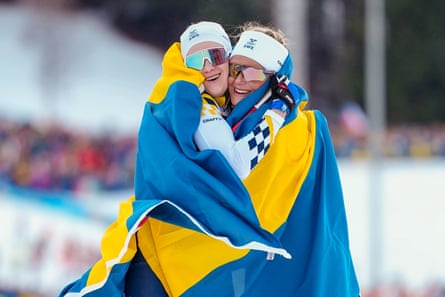 Frida Karlsson and Ebba Andersson hug after Sweden’s one-two finish in Saturday’s skiathlon.