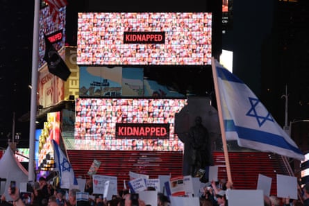 The images of hostages held by Hamas in Gaza are displayed on a billboard at a rally in Times Square on 19 October in New York City.