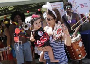 Health workers distribute information about the Zika virus to carnival-goers at Ipanema beach, Rio, Brazil