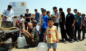 Syrians queue for water at a shelter in Hirjalleh, a rural area near the capital Damascus.