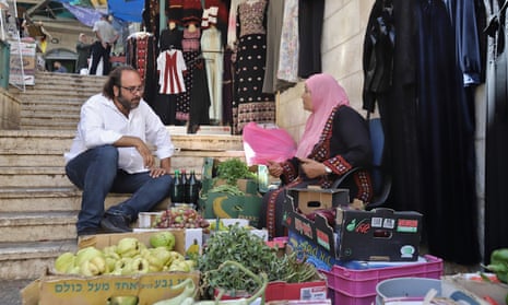 Chef Fadi Kattan discusses fresh ingredients for his dishes with street seller Umm Nabil in the Bethlehem souq