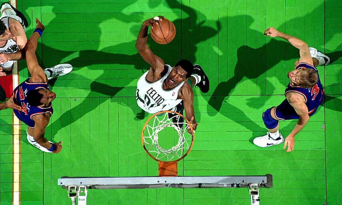 Robert Parish of the Boston Celtics goes up for a slam dunk against the New York Knicks in 1991.