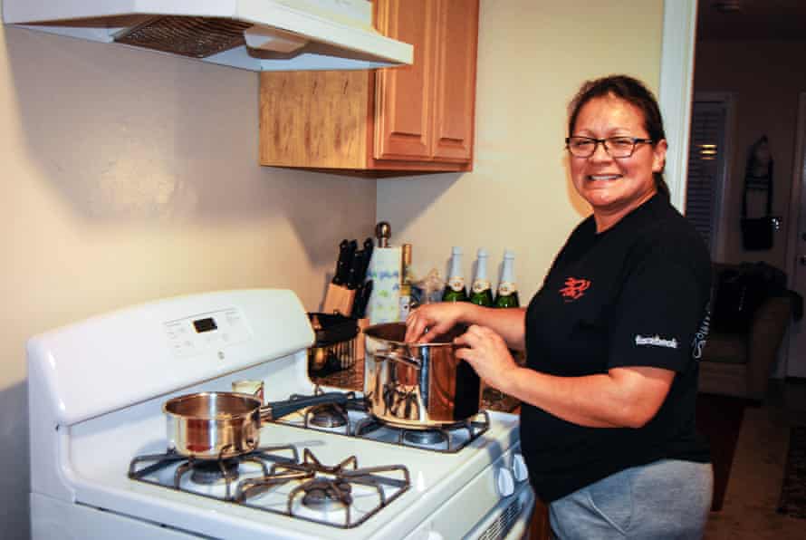 Karla Peralta, who works at the cafeteria in Facebook, demonstrates in her kitchen at home how she cooks with ingredients she picks up from the food bank.