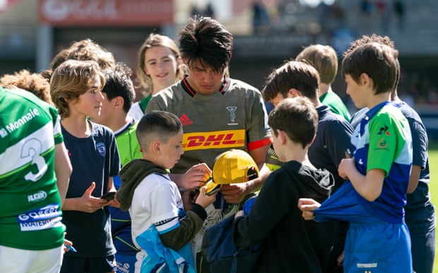 Harlequins’ Marcus Smith signs autographs for fans after the game against Montpellier.