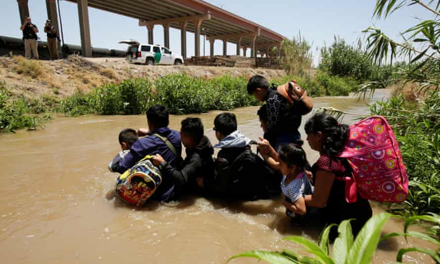 Migrants from Guatemala cross the Rio Bravo river to enter the US illegally in El Paso, Texas.