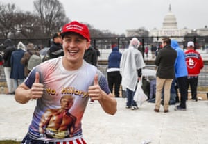 John Watson of Jacksonville, Florida, waits in the rain on the National Mall in Washington before the event