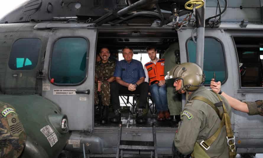Jair Bolsonaro in a helicopter to see the damage caused by landslides and floods in northern Brazil.