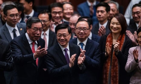 Hong Kong's Chief Executive John Lee Ka-chiu applauds with lawmakers following the passing of the Basic Law Article 23 legislation in Hong Kong.
