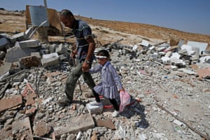Hebron, West Bank
A Palestinian man and his daughter walk through the debris of their house after it was demolished by Israeli forces