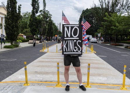 A protesters in Washington with a ‘NO Kings’ sign to voice dissent during the army anniversary parade.