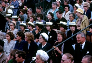 A group of schoolgirls in straw boaters watch the action in 1963