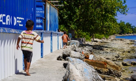 Children play along the coastline in Funafuti, Tuvalu.