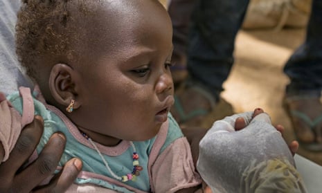 A child in Bankass, Mali, is tested for malaria by a community health worker