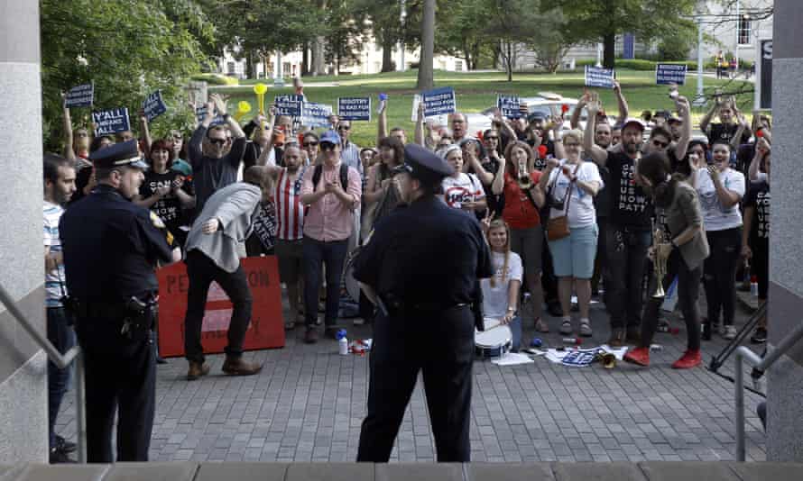 Protesters gather outside the North Carolina museum of history as the governor makes remarks about HB2 during a government affairs conference in Raleigh.