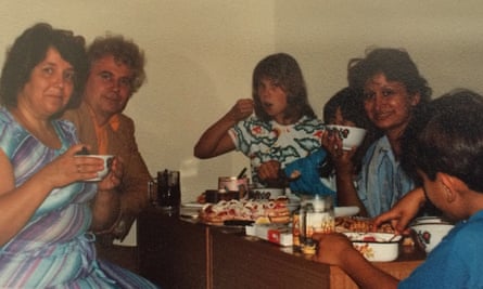 Writer Dina Nayeri (hidden) and her mother (holding cup) having tea with a family of Russian refugees at hotel Barba refugee camp near Rome in 1989