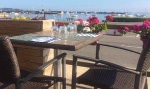 outside table overlooking harbour at Le Brise Lames restaurant, Roscoff, France.