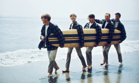 Beach Boys On The Beach With A Surfboard
LOS ANGELES - AUGUST 1962: Rock and roll band The Beach Boys walk along the beach holding a surfboard for a portrait session in August 1962 in Los Angeles, California. (L-R) Dennis Wilson, David Marks, Mike Love, Carl Wilson, Brian Wilson