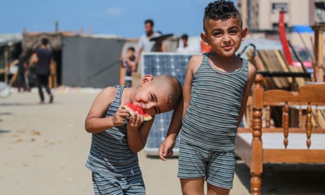 Two boys pose for the camera at a camp sheltering displaced Palestinians in Khan Younis.