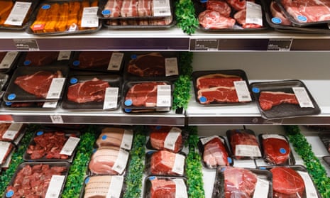 A raw meat fridge containing packs of steak, beef and pork in a supermaket