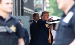 Former president Donald Trump waves while leaving Trump Tower on his way to Manhattan criminal court.