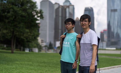 Joshua Wong (L) and Alex Chow, leaders of Hong Kong’s ‘Umbrella Movement’, before their court appearance