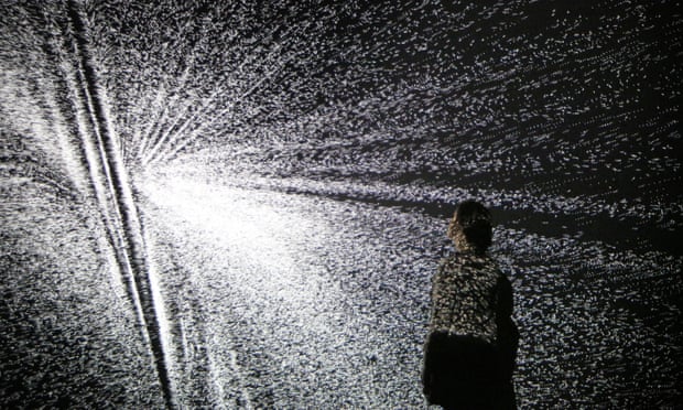 A visitor looks at an installation by artist Ryoji Ikeda at the Big Bang Data exhibition.