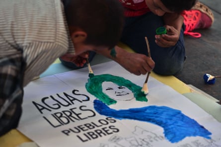 Children paint a sign during a ceremony to commemorate the fourth anniversary of the murder of environmental activist Berta Cáceres, in La Esperanza, on March 2, 2020.