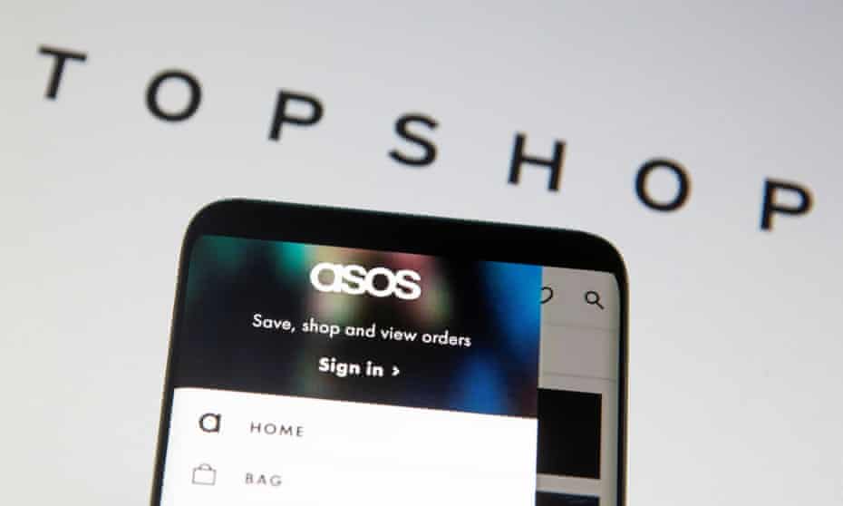 Asos seen on a smartphone with the Topshop logo behind