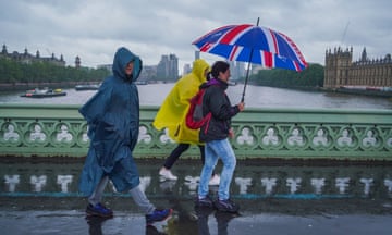 Pedestrians in rain on Westminster Bridge in London