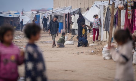 Children play at a camp for displaced Palestinians in Deir al-Balah, central Gaza, 16 January 2025.