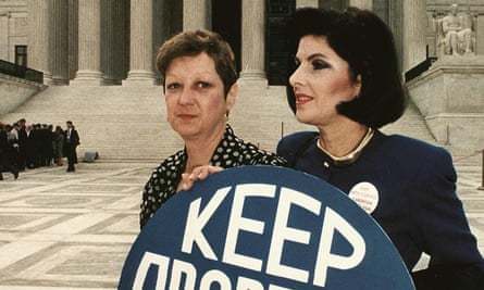 Norma McCorvey and Gloria Allred hold a sign saying 'keep abortion legal' in front of the US Supreme Court