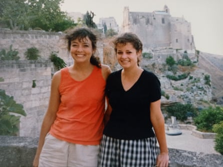Two women stand side by side wearing shorts and T-shirts on holiday in Italy.