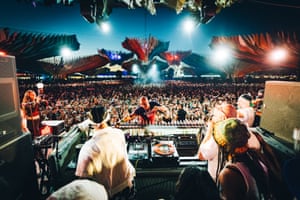 Looking out from behind the DJs’ decks at the crowd under a night sky