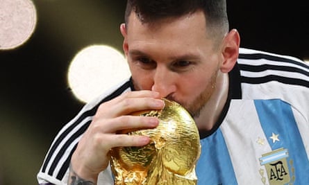 Lionel Messi kisses the World Cup trophy.