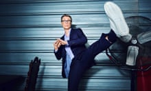Stephen Merchant doing a high kick and looking into the camera