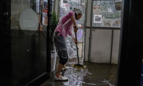 US-WEATHER-FLOOD<br>A shopkeeper clears floodwater from her store in Brooklyn, New York on September 29, 2023. (Photo by Ed JONES / AFP) (Photo by ED JONES/AFP via Getty Images)