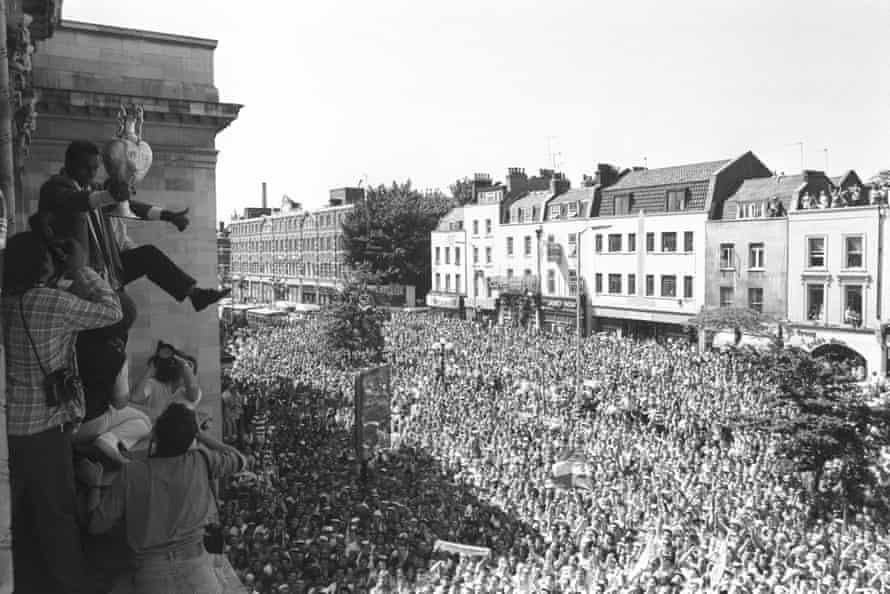 Up the Gunners ... fans watch Arsenal midfielder David Rocastle perform a victory dance on the balcony of Islington Town Hall during the team's comeback parade after beating Liverpool in 1989.