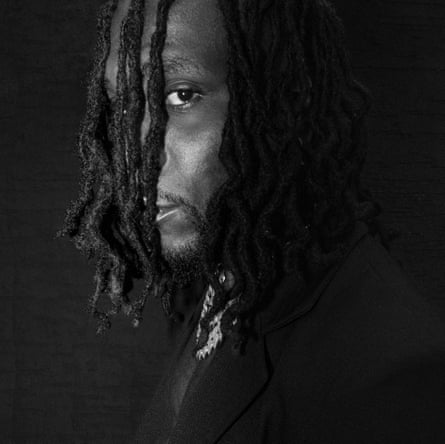 A black-and-white portrait of Burna Boy