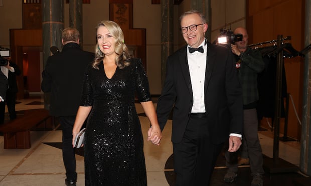 Anthony Albanese holding hands with Jodie Haydon. Albanese is wearing a tux and Haydon is wearing a black sequinned dress