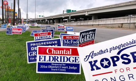 Political campaign signs stand outside a polling station in Austin, Texas Monday.