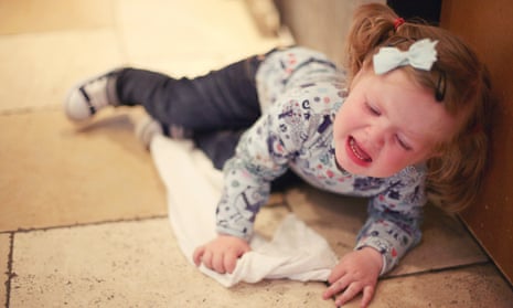 Toddler having tantrum on the floor.