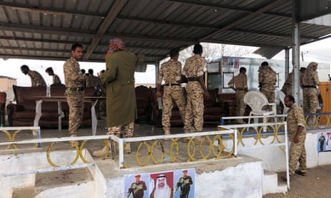 Soldiers inspect the scene of the Houthi drone attack at a military parade.