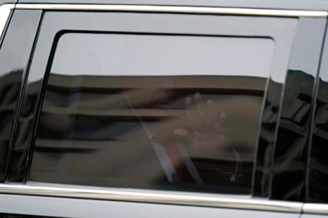 Donald Trump waves from his motorcade as he leaves the E. Barrett Prettyman U.S. Federal Courthouse.